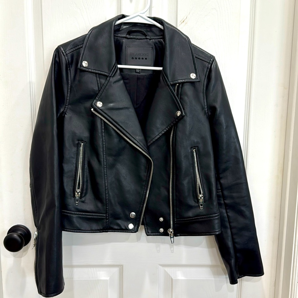 Faux black leather jacket with zippers and snaps. Women’s size small.